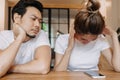 Man gets bored as woman chats on the phone for long time. Asian couple in cafe