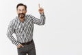 Man gets excited of everything. Portrait of impressed and amused good-looking businessman in striped shirt and pants