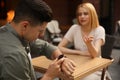 Man getting bored during first date with overtalkative woman at outdoor cafe Royalty Free Stock Photo