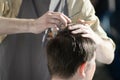 man getting haircut at barber shop. Hairdresser cutting hair of customer at salon. Royalty Free Stock Photo