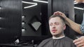 Man getting his hair styled by professional barber