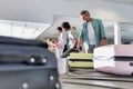 Man getting his suitcase on baggage claiming area in airport