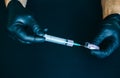 Man is getting an injection from broken ampule. Medical treatment of a low quality. Black gloves. Syringe with drugs Royalty Free Stock Photo