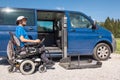 Man getting out the van by using a wheelchair car lift Royalty Free Stock Photo