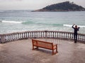 Man is getting ready for surfing at La Concha Beach in San Sebastian Royalty Free Stock Photo