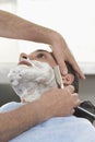 Man Getting Shave At Barbershop