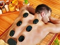 Man getting stone therapy massage . Royalty Free Stock Photo