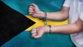 A man getting under arrest in the Bahamas. Concept of being handcuffed, detained, incarcerated and jailed in said country.