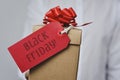 Man with a gift box with the text black friday