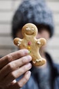 Man with a gingerbread man cookie