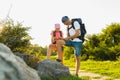 Man and girl with backpack resting and looking at map Royalty Free Stock Photo