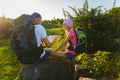 Man and girl with backpack resting and looking at map Royalty Free Stock Photo