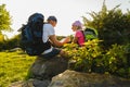Man and girl with backpack resting and looking at map Royalty Free Stock Photo