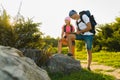 Man and girl with backpack resting and looking at map Royalty Free Stock Photo