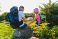 Man and girl with backpack resting and looking at map Royalty Free Stock Photo