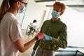 Man and girl bumping fists in medical gloves