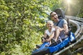 Man and girl enjoying a summer fun roller coaster ride