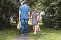 A man and a girl, father and daughter with cotton string bags, bags of groceries in nature. Caring for the ecology of the planet.