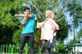 a man and a girl in a headscarf in sportswear perform leg and hand stretches Royalty Free Stock Photo