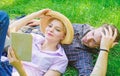 Man and girl lay on grass reading book. Family enjoy leisure with poetry or literature book grass background. Couple Royalty Free Stock Photo