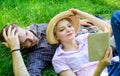 Man and girl lay on grass reading book. Family enjoy leisure with poetry or literature book grass background. Couple Royalty Free Stock Photo