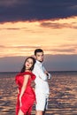 Man and girl posing against the backdrop of the sea sunset. Royalty Free Stock Photo