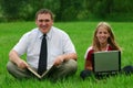 Man and girl sitting on the grass Royalty Free Stock Photo