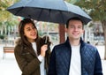 Man and girl smiling under umbrella outdoors Royalty Free Stock Photo