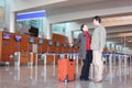 Man and girl with suitcase standing in airport Royalty Free Stock Photo