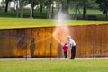 Man and girl washing wall at Vietnam memorial Royalty Free Stock Photo