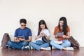 Man and girls friend classmates sitting useing technology Royalty Free Stock Photo