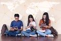 Man and girls friend classmates sitting useing technology Royalty Free Stock Photo