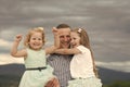 Man and girls happy smile on summer day in mountain. Fathers day concept