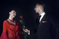 Man give rose flower to happy woman in red dress Royalty Free Stock Photo