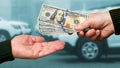 A man gives another man money for a car. Payment for the purchase or repair of a car_ Royalty Free Stock Photo