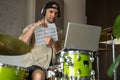 Man gives drum lesson via laptop. Guy demonstrates notes