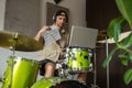 Man gives drum lesson via laptop. Guy demonstrates notes