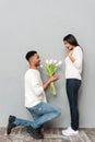 Man gives a flowers and wedding ring to woman. Royalty Free Stock Photo