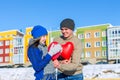 The man gives the girl a balloon heart on Valentine`s Day
