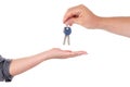 A man gives the keys to the lock of a woman close-up on a white background. male and female palms with keys