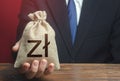 Man gives a polish zloty money bag. Loan issuance. Investments, financing Lobbying. Funding. Accounting, tax payment. Earnings and