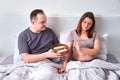 A man gives a pregnant woman a tray with sweets - refusal of improper nutrition during pregnancy, weight control Royalty Free Stock Photo