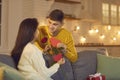 Man gives a rose, a gift and valentines to his beloved woman in honor of Valentine`s Day. Royalty Free Stock Photo