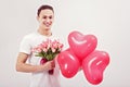 man gives tulips and heart-shaped balloons