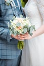 Man gives wedding flowers girl. Close-up. Wedding bouquet. Beautiful bridal bouquet in hands of young bride dressed in white weddi Royalty Free Stock Photo