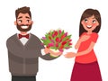 Man gives a woman a bouquet of flowers. Congratulations on a holiday or birthday Royalty Free Stock Photo