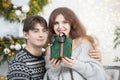 A man gives a woman a Christmas present Royalty Free Stock Photo