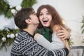 A man gives a woman a Christmas present. Husband and wife in the New Year holidays Royalty Free Stock Photo