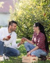 Man giving apple to girl in orchard Royalty Free Stock Photo
