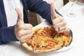 Man giving a baked homemade pizza a thumbs up Royalty Free Stock Photo